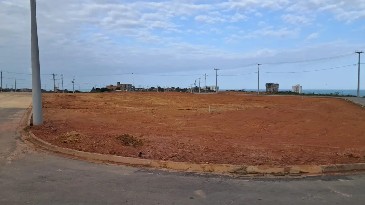 O terreno da praça principal do Condomínio Tramonto, já regularizado, com o mar ao fundo, na obra de agosto de 2026